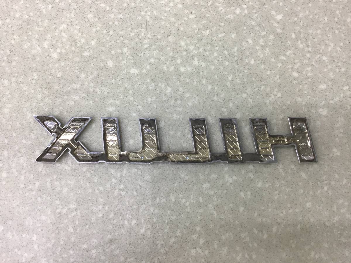 Эмблема Toyota Hilux (GUN125L, GUN126L, TGN126) 2015-н.в. Эмблема Toyota Hilux (GUN125L, GUN126L, TGN126) 2015-н.в.