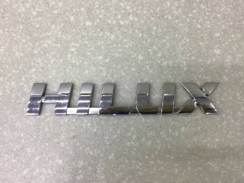 Эмблема Toyota Hilux (GUN125L, GUN126L, TGN126) 2015-н.в. Эмблема Toyota Hilux (GUN125L, GUN126L, TGN126) 2015-н.в.