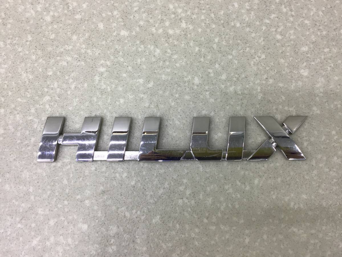 Эмблема Toyota Hilux (GUN125L, GUN126L, TGN126) 2015-н.в. Эмблема Toyota Hilux (GUN125L, GUN126L, TGN126) 2015-н.в.